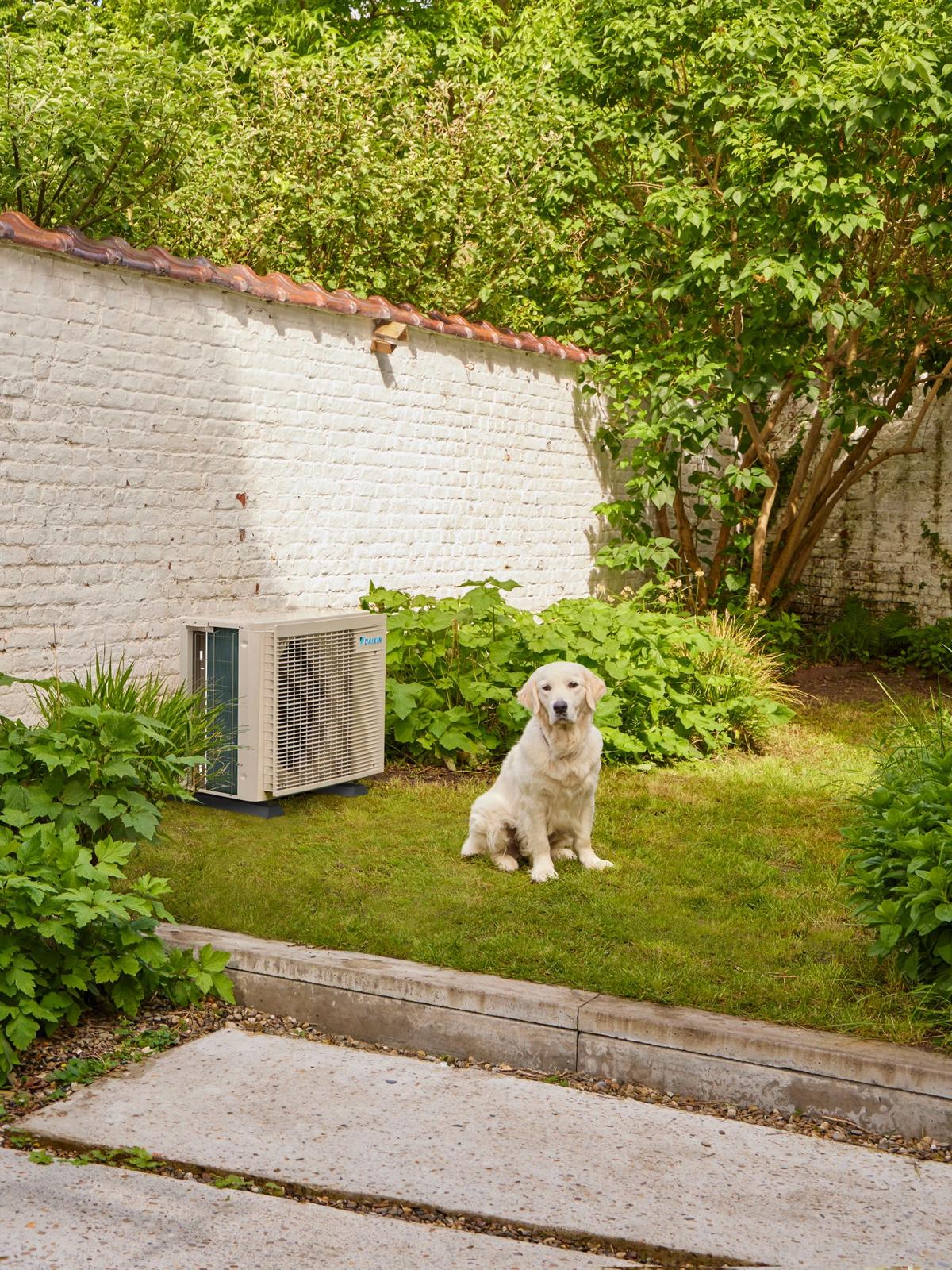 Outdoor air conditioning unit installed neatly in a garden